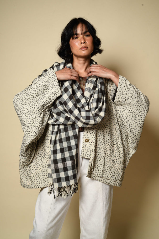 woman with a black and white check scarf inspired by the gamcha textile