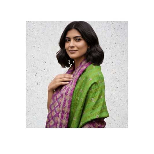 A woman wearing a pink and green silk sari kantha shawl