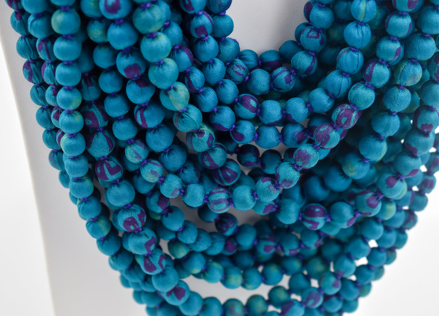 Peacock — Sari Silk Bead Necklace, 22-String — Teal and Purple — worn on neck